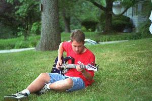 Erik playing his Carvin on the lawn in front of Danny's house.